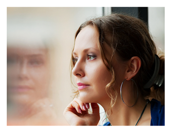 Woman-looking-through-window-and-contemplating